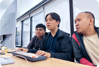 Team members brainstorming with sticky notes on a whiteboard